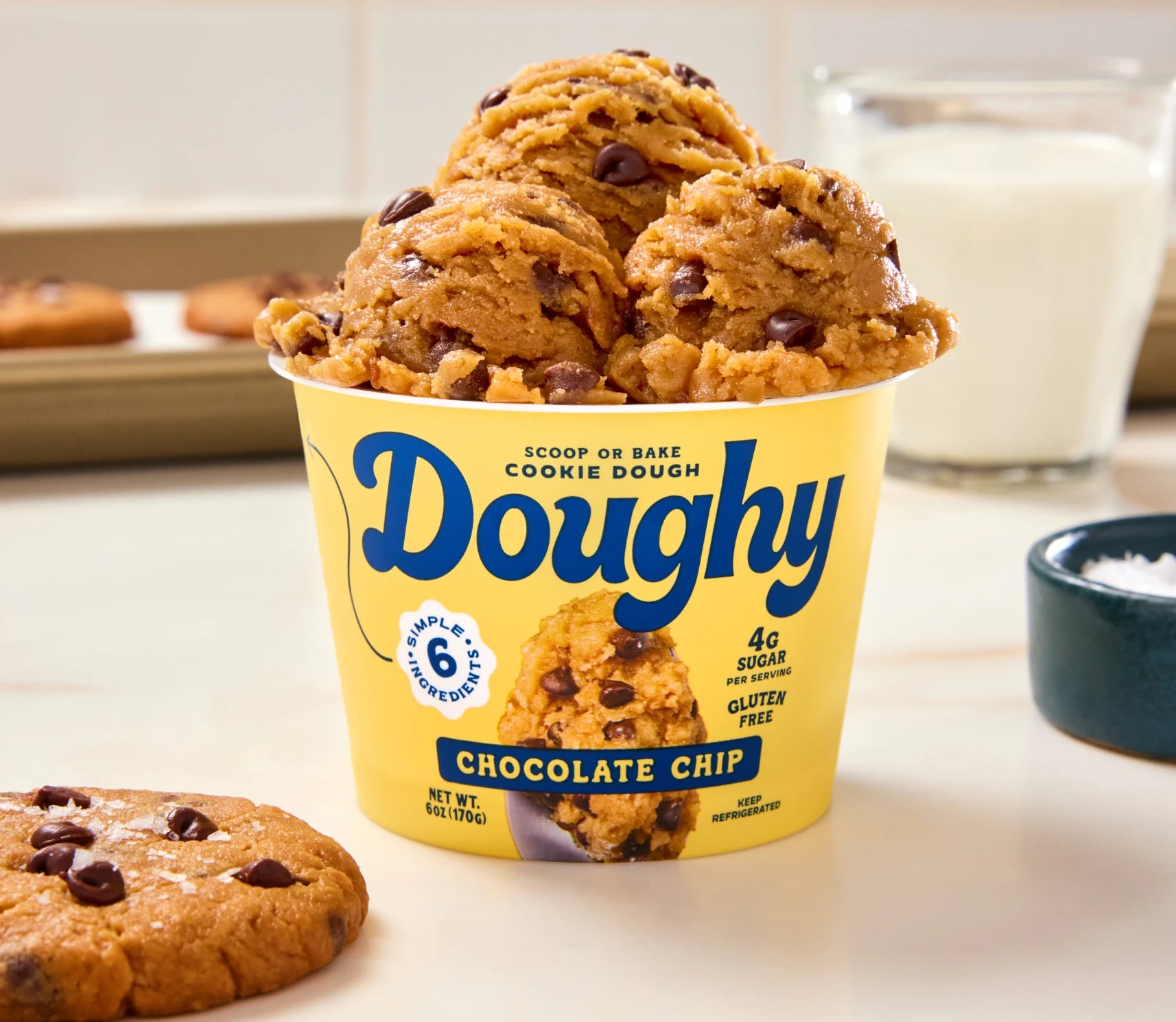 A cup of Doughy cookie dough with a glass of milk